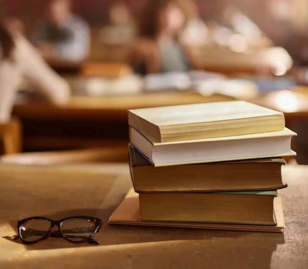 Stack of books and glasses on table